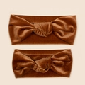 Detail of brown velvet knotted headbands showing soft texture and twisted knot design - Brown
