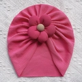 Detailed shot of pink textured baby turban hat with a large 3D flower and button center - Rose Red