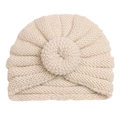 Close-up of beige knit baby donut hat showing soft texture and cozy weave pattern - Beige