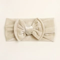 Close-up of champagne velvet baby headband with a soft oversized double-layered bow - Beige