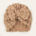 Detail of baby turban hat with oversized bow and textured bubble fabric in milk tea color - Coffee