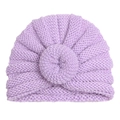 Close-up detail of soft light purple knitted baby turban hat with donut knot texture - Purple