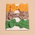 Close-up of 3-piece baby headbands set with large bows and waffle knit texture details - Yellow and Green (No Card-Style F)