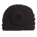 Close-up of a dark knit baby donut hat with soft texture and spiral crochet pattern - Black
