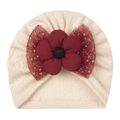 Detail of beige baby knit hat featuring a burgundy fabric flower and gold glitter mesh bow - One Size / Beige