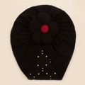 Detail showing breathable hollow dot fabric and large fabric flower on infant beanie - Black