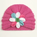 Detail of baby turban knit hat in bright pink with a multicolor handmade fabric flower - Rose Red