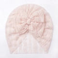 Detailed view of pale pink lace baby turban with a large decorative soft bow - Pink