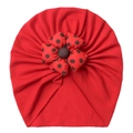 Detailed close-up of a red baby turban hat featuring a 3D polka dot fabric flower ornament - One Size / Red