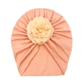 Detail of baby turban hat in lotus pink with cream fabric rose and soft knit texture - Nude Pink