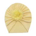 Close-up of soft cotton baby hat with a large decorative flower in light yellow - Beige