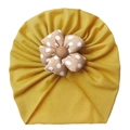 Detail of soft yellow baby turban hat with polka dot flower and ribbed cotton texture - One Size / Earthy Yellow