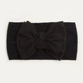 Detailed close-up of soft black nylon baby headband with a large elastic bow knot design - Black