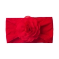 Detail of red elastic baby headband featuring a large layered fabric floral ornament - Red