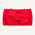 Detail of red nylon baby headband featuring a large bow and soft ribbed texture - Red
