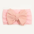 Detail of soft pink baby nylon headband featuring a large hand-tied bow decoration - Pink