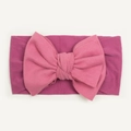 Close-up of soft nylon fabric texture and large bow detail on baby headband - Deep Purple