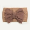 Detailed close-up of baby nylon headband with coffee brown bow on soft ribbed fabric - Coffee