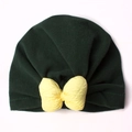 Close-up of baby knot hat with a yellow textured bow and dark green velvet fabric - Dark Green