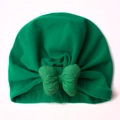 Detail of baby turban hat showing the large bow knot and green soft ribbed fabric texture - Green