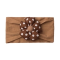 Detail of baby elastic headband featuring a large brown polka dot fabric flower design - Brown