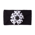 Detail of baby elastic headband featuring soft black fabric and polka dot floral ornament - Black