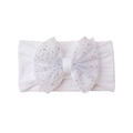 Close-up of white elastic baby headband featuring a large sparkling silver glitter bow - White