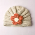 Cute beige baby knitted turban hat featuring a large orange flower for winter warmth - Beige
