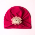 Close-up of baby beanie with cute cartoon lion patch on soft magenta knitted fabric - One Size / Rose Red