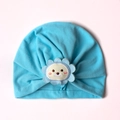 Detail of baby blue pleated turban hat with a cute cartoon lion embroidery patch - One Size / Blue