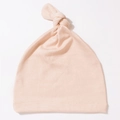 Close-up of soft light pink newborn knotted baby hat made from premium knit fabric - Dusky Pink