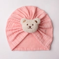 Detail of pink knitted baby hat featuring a cute white plush bear head and cable texture - One Size / Snow Bud