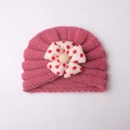 Rose pink baby knit turban hat featuring a large red polka dot bow and wooden bead - Dusky Pink