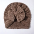Detail of soft brown plush knit baby hat with a large decorative bow and fuzzy texture - One Size / Coffee