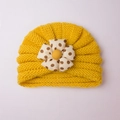 Yellow knitted baby hat with large polka dot flower decoration for winter warmth - Yellow