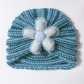 Detailed knit texture of a baby striped hat with a large floral lace embellishment - Blue