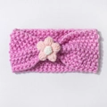 Detail of pink hand-crocheted baby headband with 3D floral accent and soft knit texture - Pink