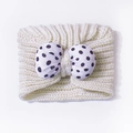 Cream knit baby headband featuring a cute white and black polka dot bow accessory - Beige