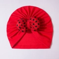 Red baby turban hat with a large black polka dot bow made of soft cotton knit - Red
