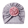 Detail of baby turban hat featuring a large pink satin rose on soft purple knit fabric - Gray