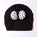 Soft black newborn turban hat featuring a large white polka dot bow decoration - Black