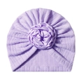 Detailed view of lavender baby turban featuring knit texture and 3D satin rose flower - Purple
