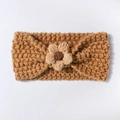 Detail of baby knitted headband featuring a handmade crochet flower in warm ginger tones - Coffee