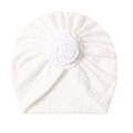 Detail of white baby turban with delicate knit texture and a large floral fabric rose - White