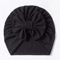 Detailed close-up of a black waffle texture baby turban hat with a large decorative bow - Black