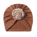 Detail of baby turban hat in caramel knit with a champagne satin rose accent - Coffee