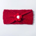 Close-up of red knitted baby headband with a handmade crochet flower decoration - Red