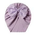 Detailed view of lavender ribbed baby hat with a large bow and silver star patterns - One Size / Purple