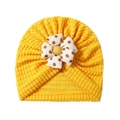 Bright yellow waffle knit baby turban hat featuring a large white polka dot fabric flower - Yellow