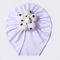 Infant head wrap in light purple knit fabric featuring a white polka dot flower detail - White